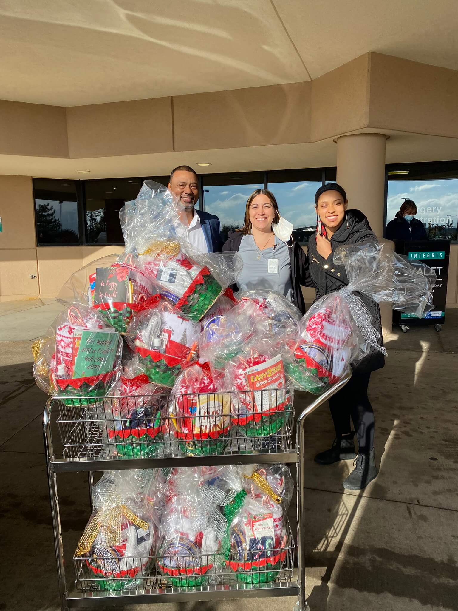 Group image of some people holding a cart full of stuff